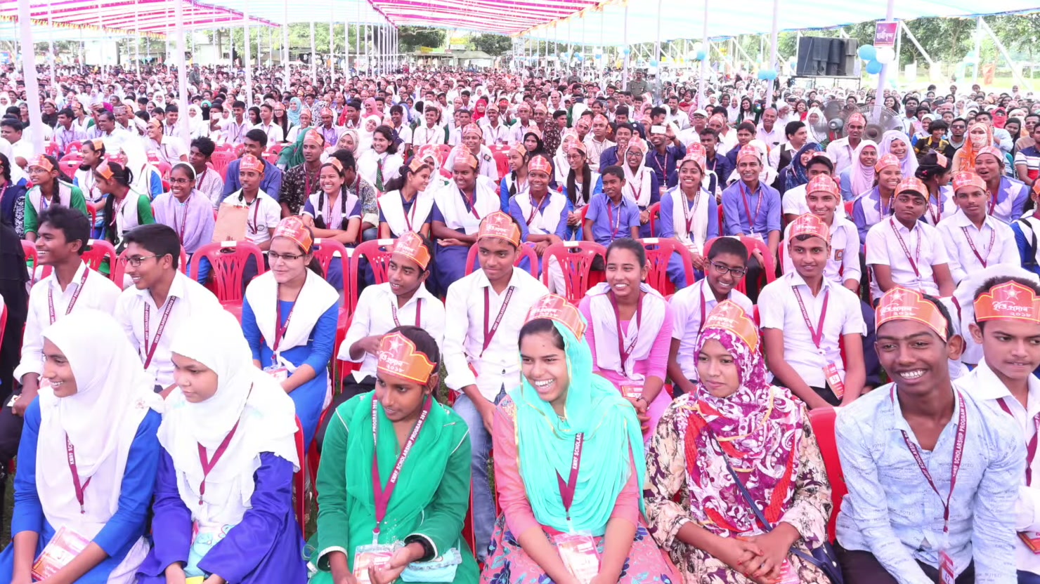Students seated beneath a decorated canopy in the 2018 scholarship montage.