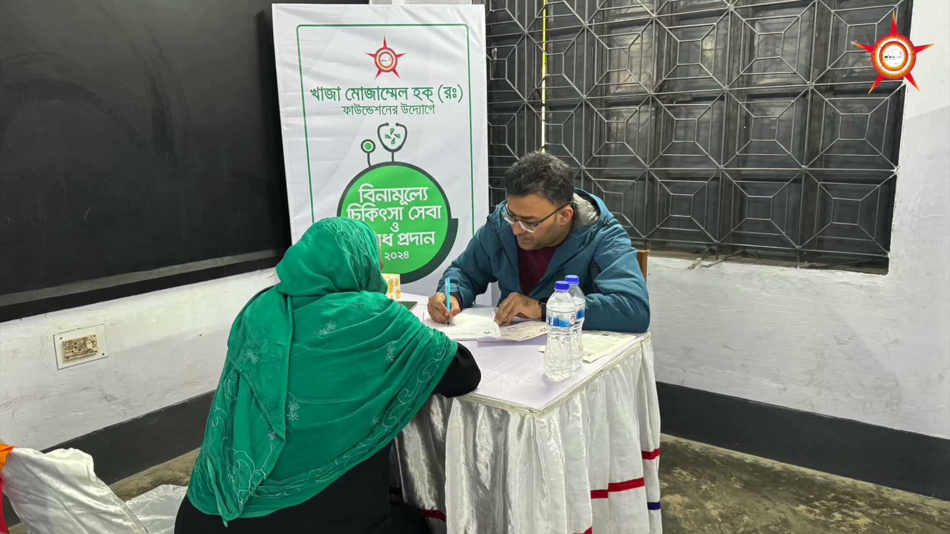 A consultation scene at a table during the medical camp.