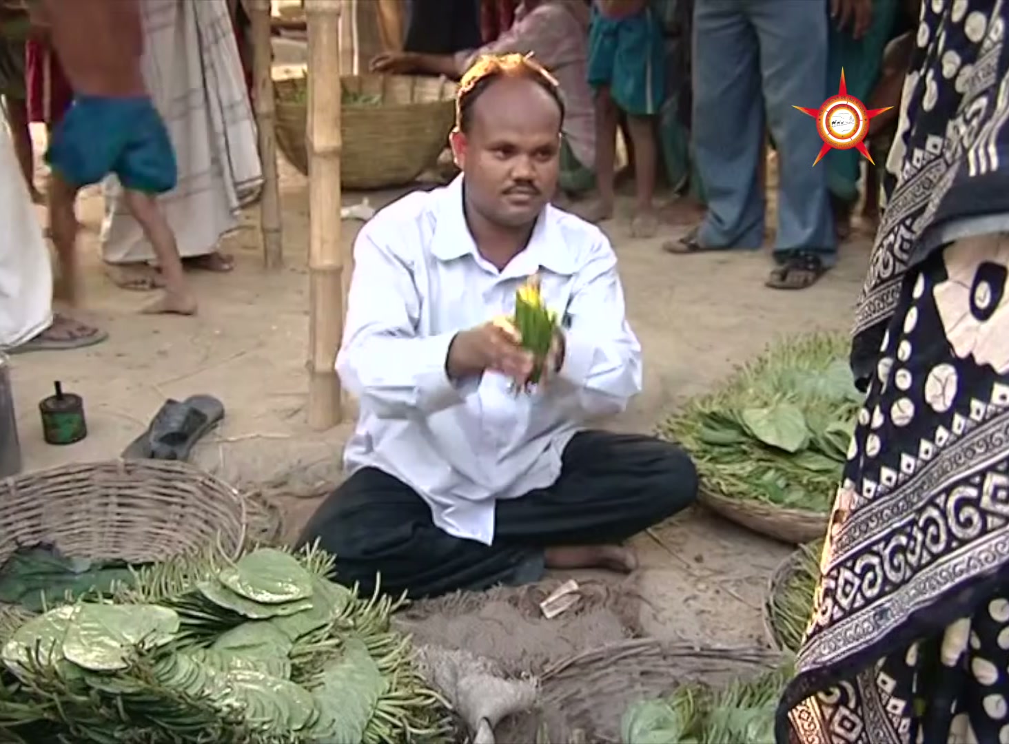 A man offers betel leaves for sale at a market in the film about Md. Lebu Mia's business.