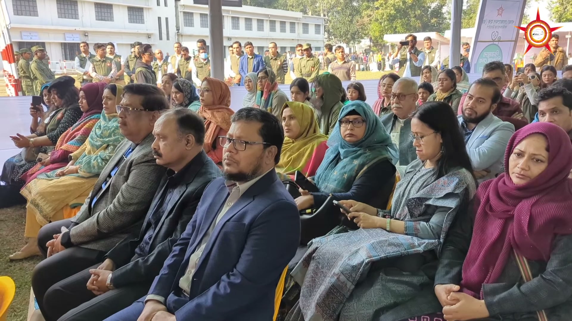 Seated guests listening during the camp address.