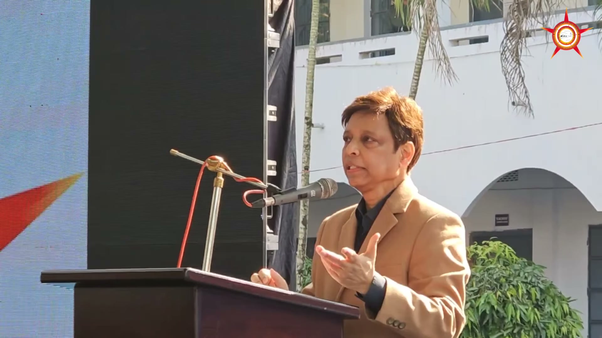 The named chairman speaking from the lectern during the camp address.
