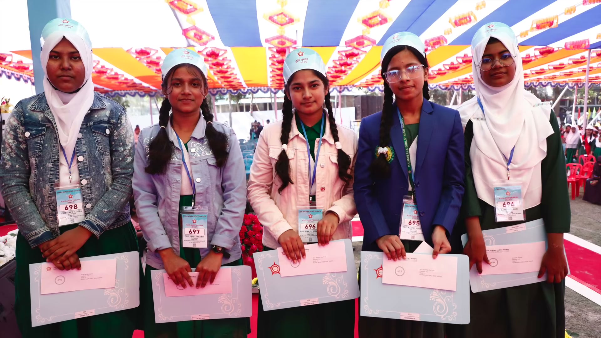 Participants holding certificates in the 2025 programme film.