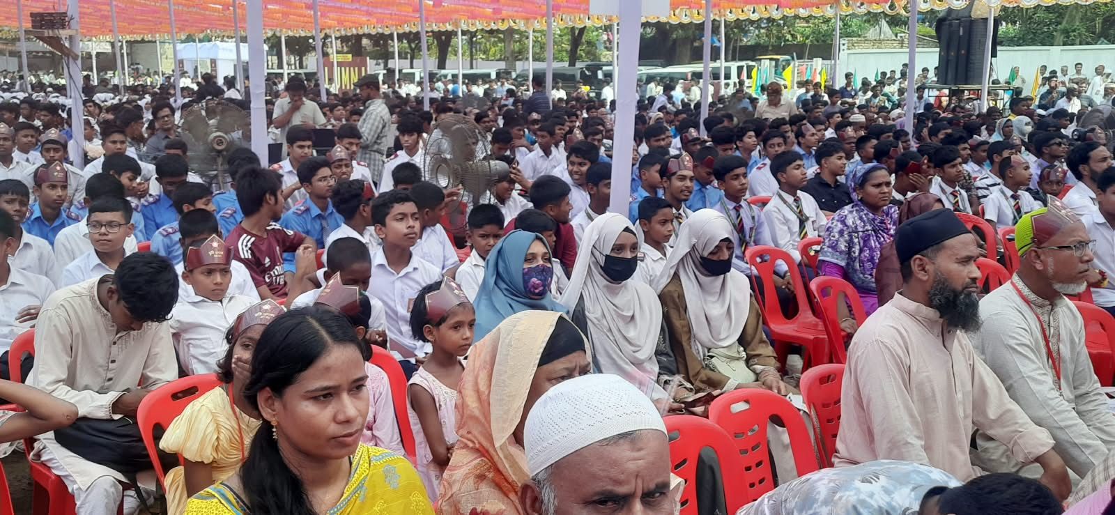 Parents, children and students seated in the front rows.